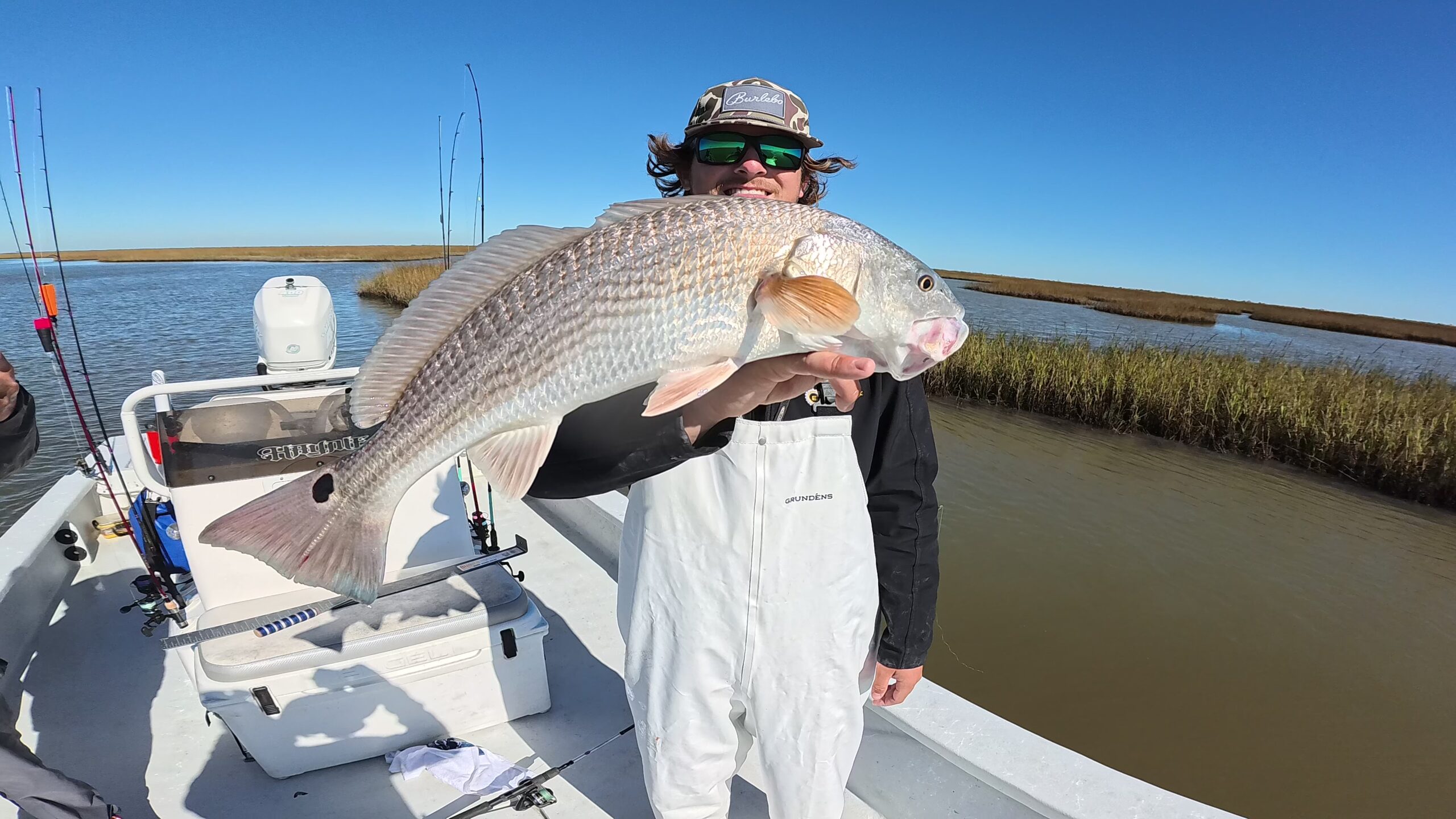 Holding a large fish on Darren's boat