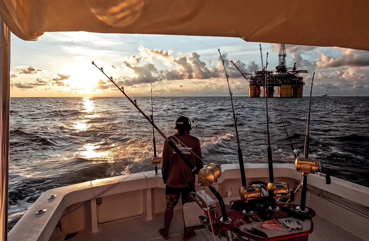 Fishing on yacht near an oil rig